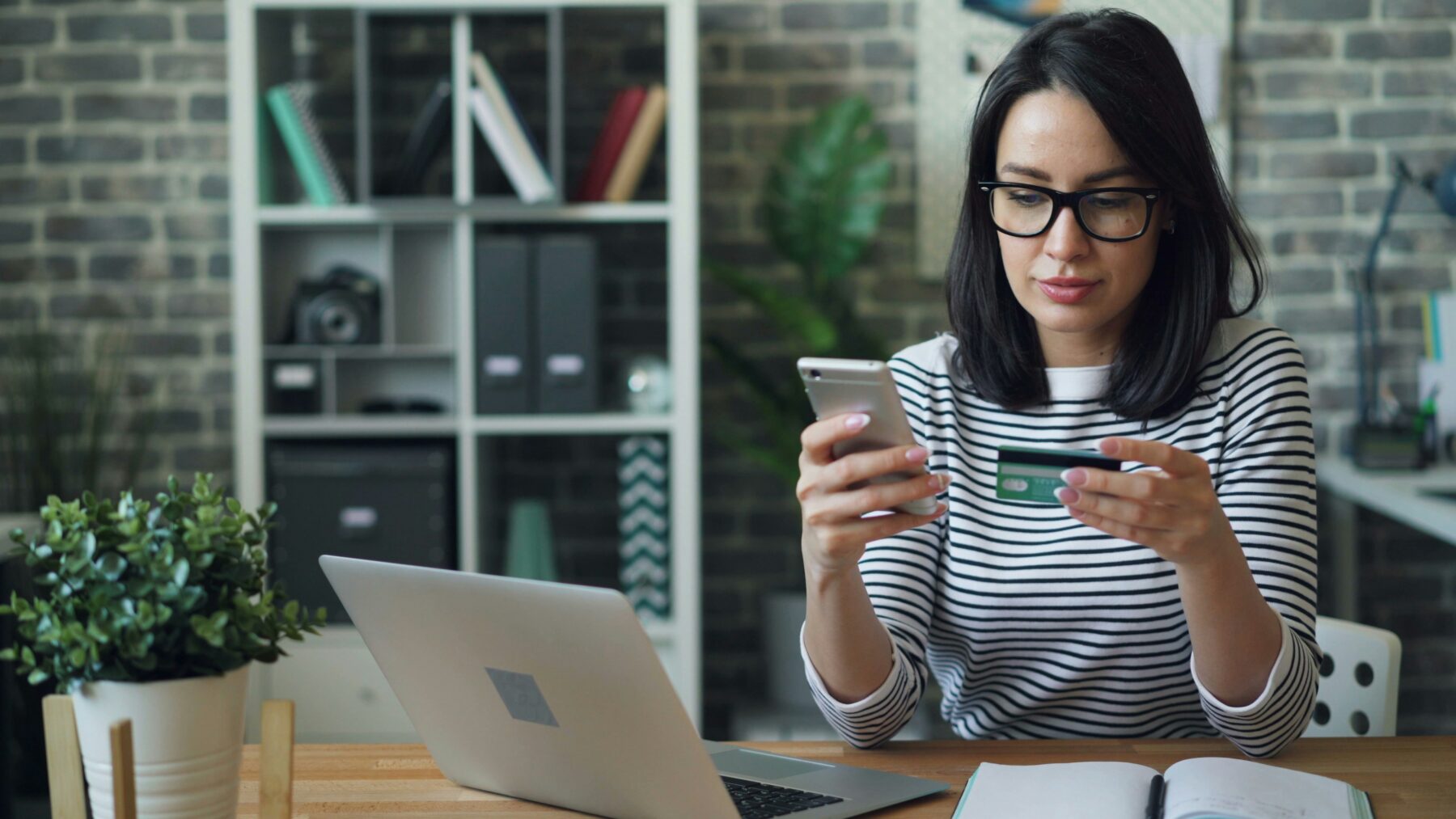 Woman making credit card payment at her desk